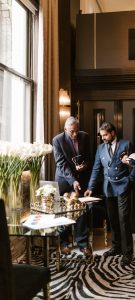 A diverse group of business professionals in a stylish office discussing a project.